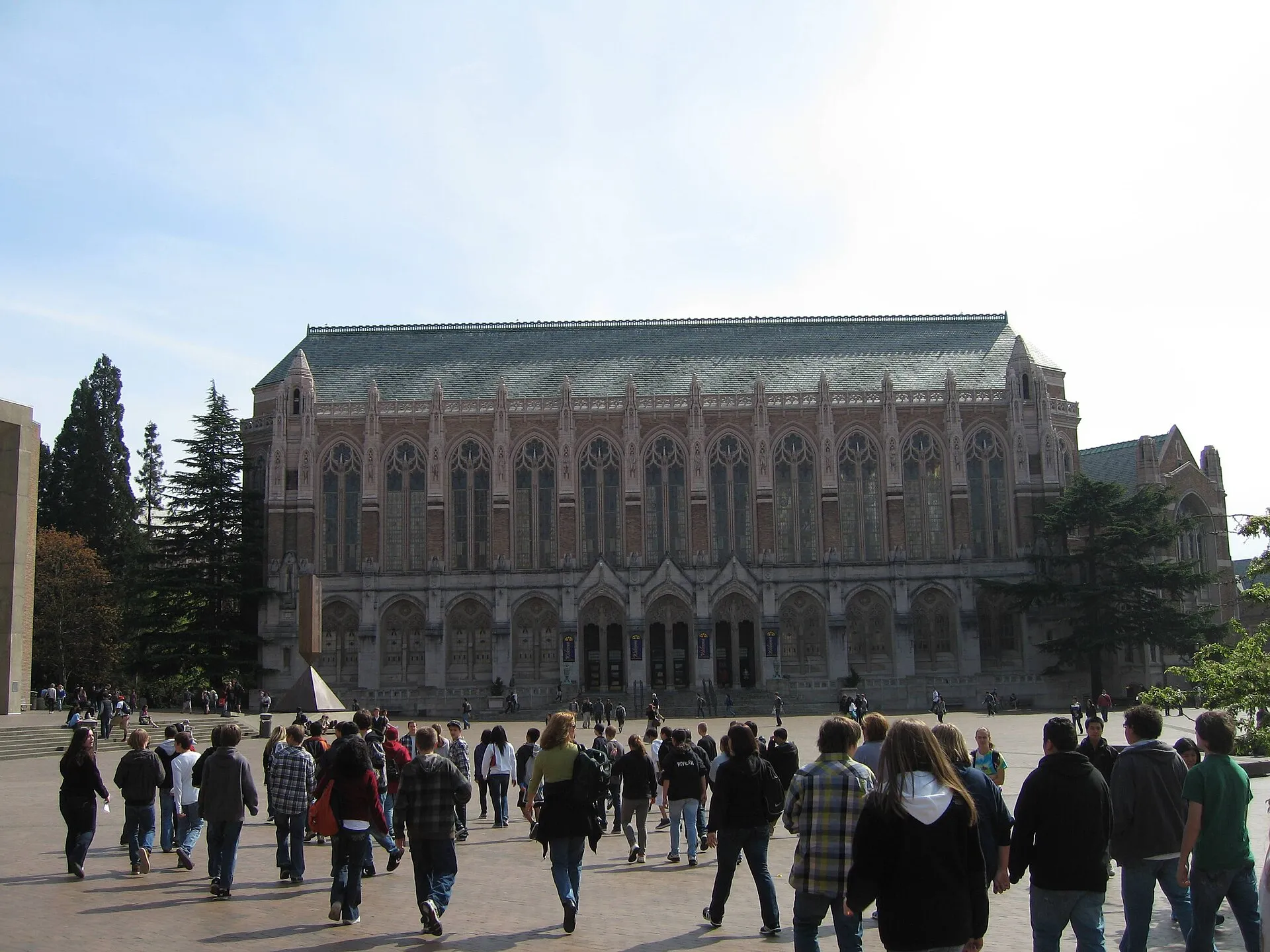 Suzzallo Library's Gothic facade across Red Square at the University of Washington, with students walking toward it